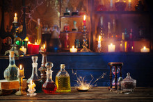 Magic Potions In Bottles On Wooden Background