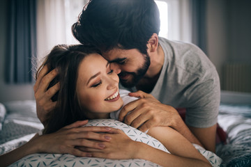 Wall Mural - Cheerful young couple making massage at home