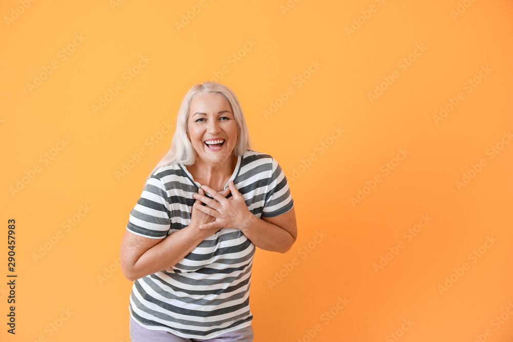Happy mature woman on color background