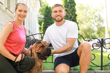 Sticker - Sporty couple with cute dog walking outdoors