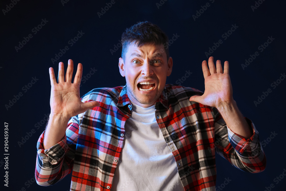 Portrait of angry man on dark background