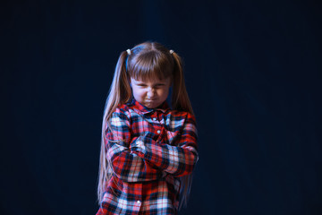 Wall Mural - Portrait of angry little girl on dark background