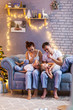 © Inna Vlasova - Christmas family with two kids in beautiful living room