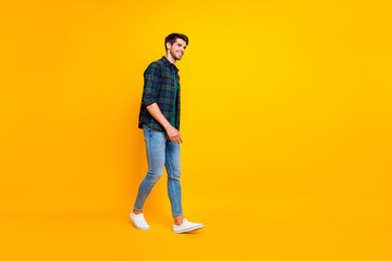 Poster - Full length body size photo of cheerful attractive guy walking towards sales wearing sneakers isolated over yellow vivid color background