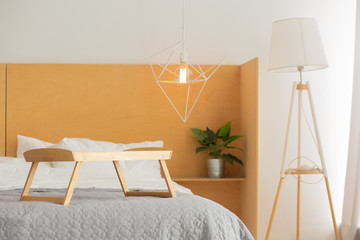 Wall Mural - The interior of the bedroom. Queen bed with bedspread. Breakfast table-tray with a cup, two croissants and a sprig of orchids on the bed.