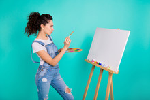 Portrait Of Nice Attractive Focused Concentrated Minded Wavy-haired Girl Wearing Casual Holding In Hands Water Color Making New Picture Isolated On Bright Vivid Shine Green Turquoise Background