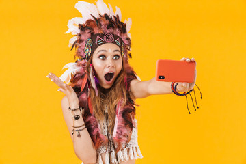 Canvas Print - Surprised indian woman in carnival suit take selfie by mobile phone.