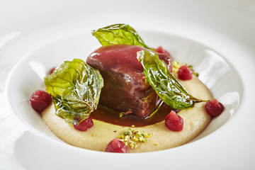 Wall Mural - Restaurant Plate of Beef Cheeks in Cherry Glaze with Potato-Celery Cream and Sauce of Dried Berries