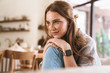 © Drobot Dean - Redhead woman indoors sitting at the kitchen at home.