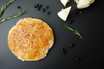 Wall Mural - Spice bread and cheese on a black background, top view