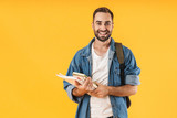 Fototapeta  - Image of content student guy smiling while holding exercise books