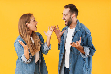 Canvas Print - Image of joyful couple smiling at each other with arms raised