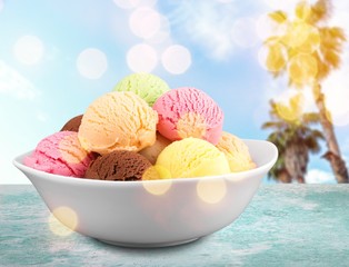 Wall Mural - Ice cream scoops in bowl on white background