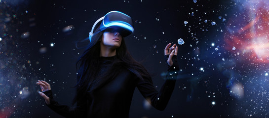 Wall Mural - beautiful woman with flowing hair in futuristic dress over dark magic light background. girl in glas