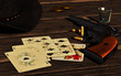 A poker hand rests on an old wooden table. It consists of five cards including the black aces and eights: the legendary dead man's hand. 3D Rendering