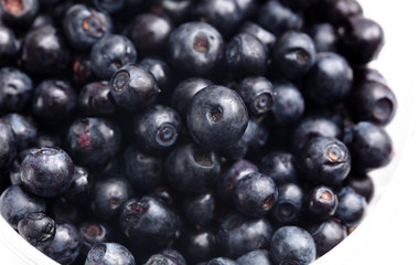 Wall Mural - Blueberries in a glass on a white background