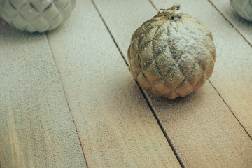 Poster - Beautiful Christmas baubles on a new wooden table fell by snow background.