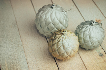 Poster - Beautiful Christmas baubles on a new wooden table fell by snow background.