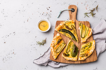 Wall Mural - Pizza with baby zucchini on wooden board - party snack