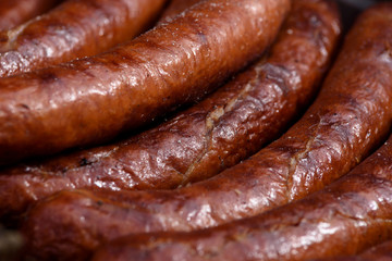 Grilling Sausages on barbecue grill in close-up (high details)