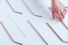 Metal Straws In A Hand On White Background. Zero Waste. Flat Lay
