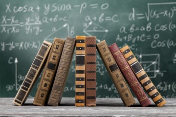 Poster - Books stack collection in a pile on wooden table