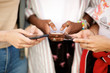 © mimagephotos - group of female hands holding smart phones