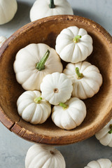 Wall Mural - white little pumpkins in a wooden bowl