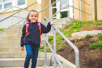 Wall Mural - A nice Portrait of cute hispanic girl with backpack at school