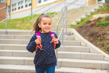 Wall Mural - A nice Portrait of cute hispanic girl with backpack at school