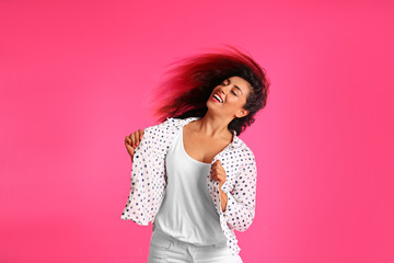 Poster - Beautiful Hispanic woman dancing on pink background