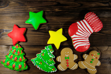 Wall Mural - Tasty festive Christmas gingerbread cookies on wooden table. Top view