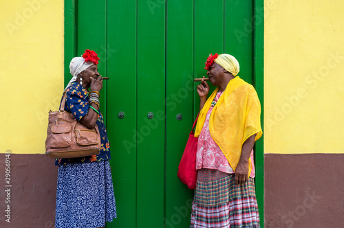 Two Old Cuban ladies smoking a large cigar in La Havana, Cuba Wallpaper Mural