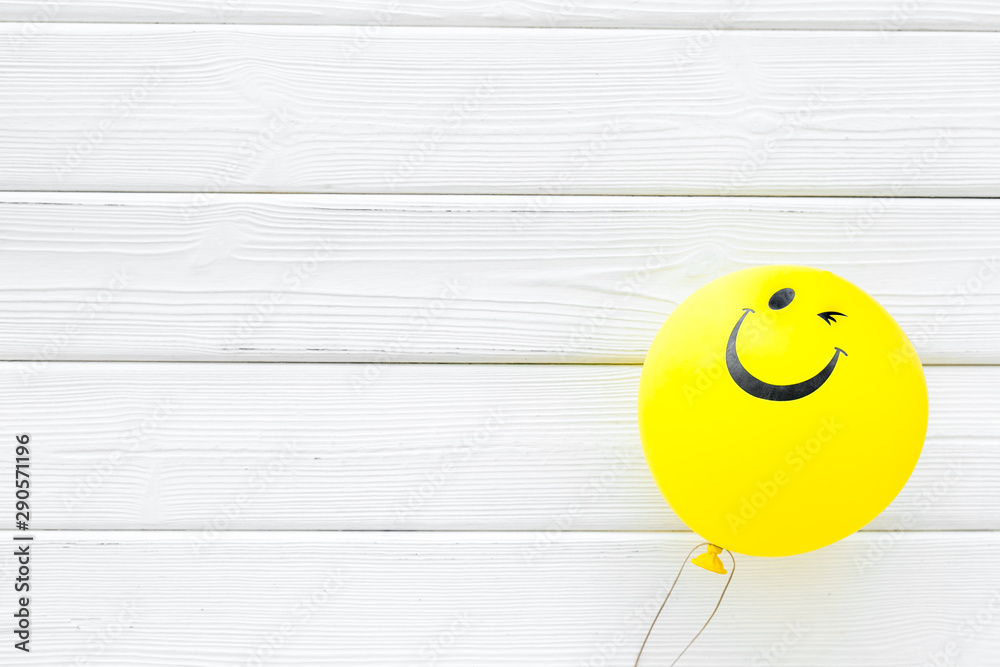 Happiness emotion. Yellow balloon with smile on white wooden background top view space for text - obrazy, fototapety, plakaty 