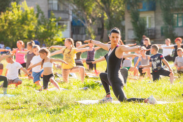 Wall Mural - children do yoga with an outdoor trainer.