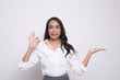 © halfbottle - Beautiful young Asian woman show palm hand and OK sign.