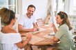 © Krakenimages.com - Beautiful family sitting on terrace drinking cup of coffee speaking and smiling