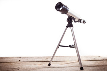 Wall Mural - telescope on a white background laid on wooden board