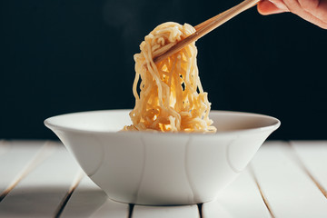 Wall Mural - Bowl of instant noodles on the table. Chopsticks