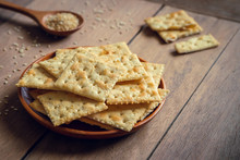 Crispy Crackers With Sesame On Wooden Plate.