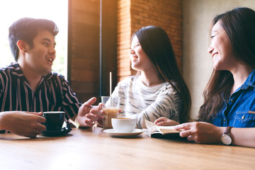 Wall Mural - A group of people enjoyed talking, reading and drinking coffee together in cafe