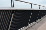 Fototapeta Zwierzęta - handrail of stainless steel at footbridge in city