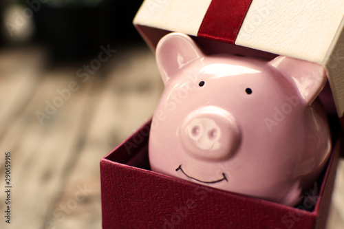 Cuadros en Lienzo Piggy bank in the gift box celebration on holiday concept.