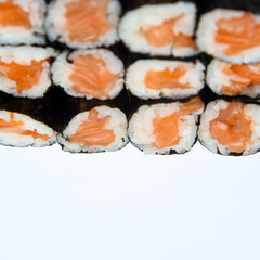 Wall Mural - Sushi Roll with salmon on the white background .Food abstract background