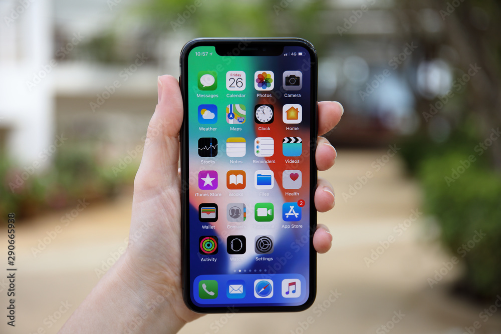 Woman hand holding iPhone X with IOS 11 on screen Stock Photo | Adobe Stock