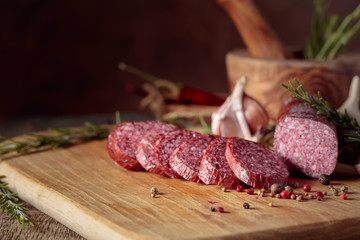 Wall Mural - Smoked salami on a old wooden table.