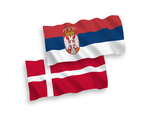 National vector fabric wave flags of Denmark and Serbia isolated on white background. 1 to 2 proportion.