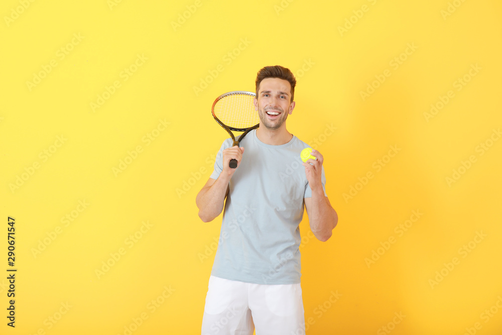 Handsome tennis player on color background