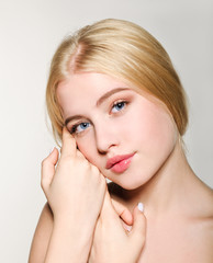 Portrait of beautiful blonde young woman face.  Spa model girl with fresh clean skin isolated on a white background