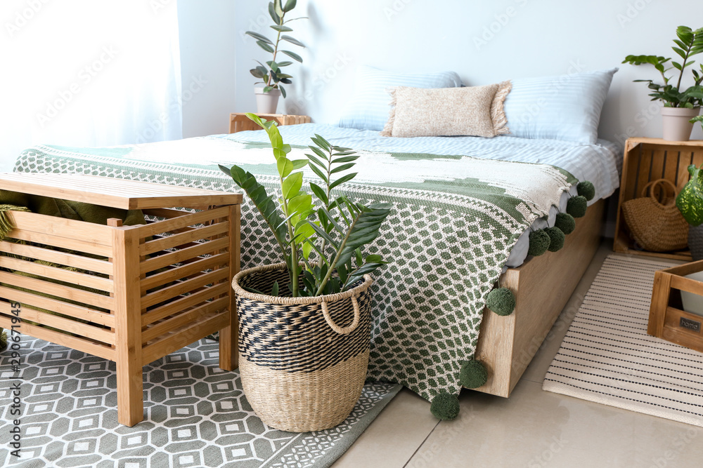 Interior of modern bedroom with houseplants